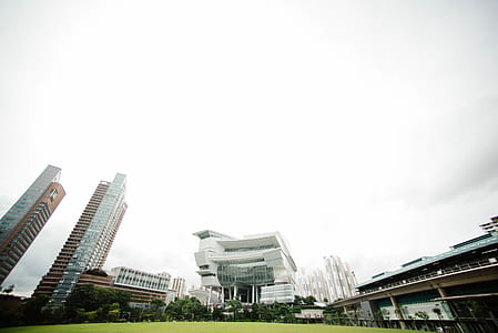 low-angled photography of buildings under nimbus cloud thumbnail