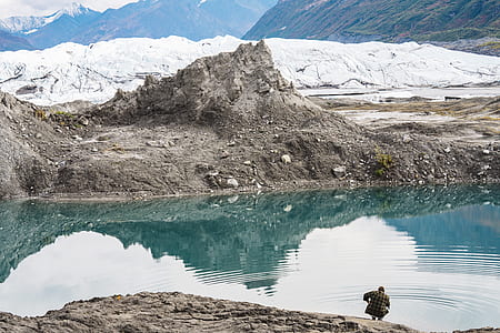 man standing near body of water during daytime thumbnail