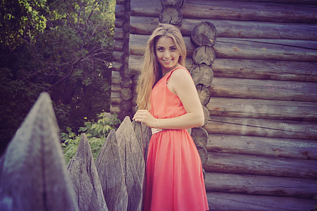 woman wearing red crew-neck sleeveless dress during daytime thumbnail