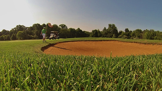 man walking on golf field thumbnail