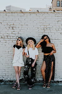 three women leaning on wall thumbnail