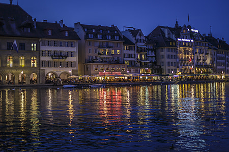 lampposts lighted up near body of water thumbnail