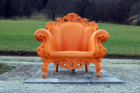 orange leather sofa chair near green field thumbnail