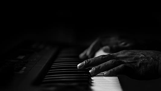 grayscale photography of person playing piano thumbnail