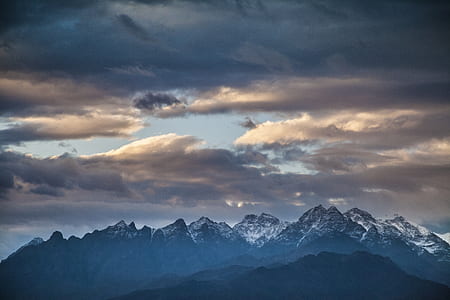 mountain under cloudy blue sky during daytime thumbnail