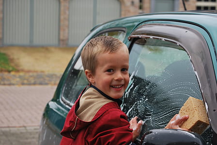 selective focus photography of boy washing car thumbnail