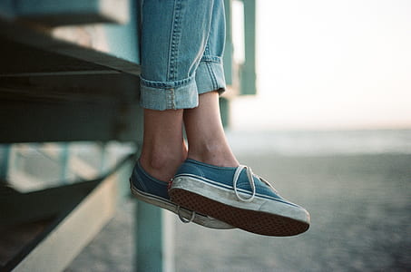 selective focus photograph of person's feet wearing blue sneakers thumbnail