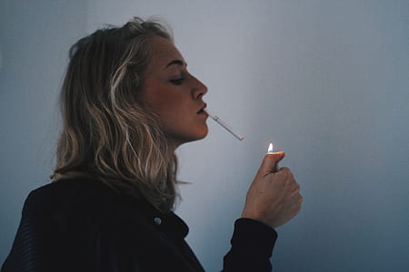 woman holding lighter and using cigarette thumbnail