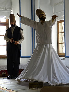 man performing dervish dance inside room thumbnail