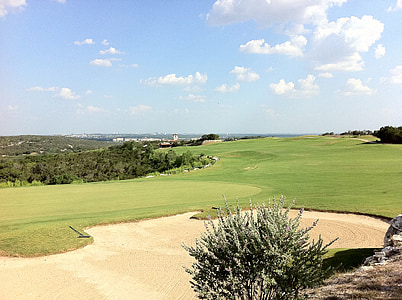 golf course under blue cloudy sky thumbnail