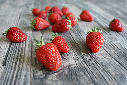 red strawberry fruits on gray wooden surface thumbnail