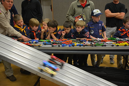 group of children standing in front of race track toy thumbnail