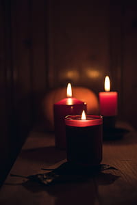 three red candles on beige surface thumbnail