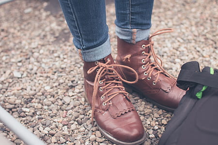 person wearing brown leather logger boots thumbnail
