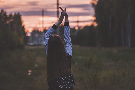 woman wearing black an white long-sleeved shirt raising her both hands thumbnail
