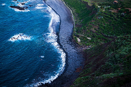 bird's-eye view photography of body of water near mountain thumbnail