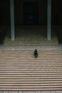 man sitting on beige stair thumbnail