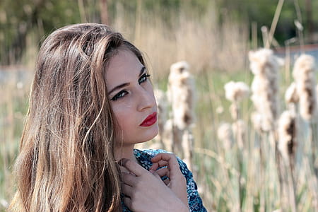 selective focus photography of woman on brown grass field during daytime thumbnail