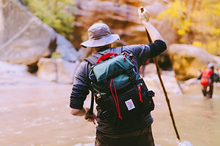 man walking on body of water holding walking cane thumbnail