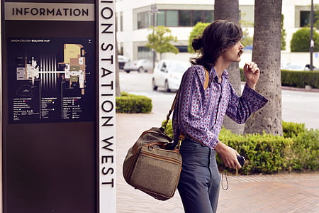 Person Wearing Purple Dress Shirt and Black Pants White Carrying Brown Sling Bag thumbnail
