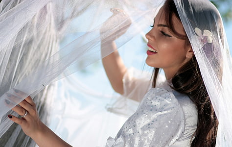 woman wearing white dress holding veil thumbnail