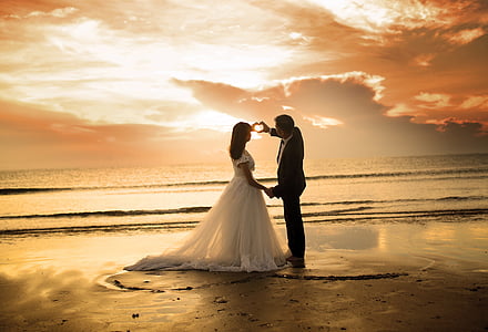 man and woman doing heart shaped hand gesture thumbnail