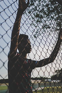 man holding fence at twilight thumbnail