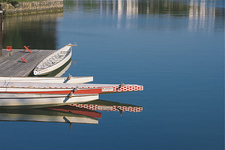 white canoe on dock during daytime thumbnail