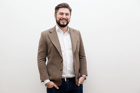 smiling man wearing brown suit jacket and white dress shirt thumbnail
