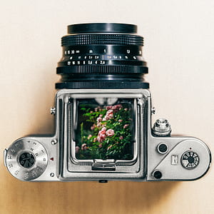 gray and black DSLR camera on beige surface thumbnail