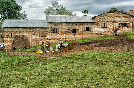 people standing near brick houses thumbnail
