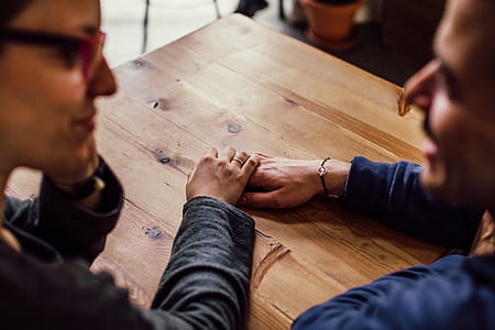 Man and Woman Sitting Together in Front of Table thumbnail