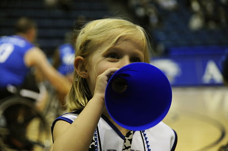 girl holding blue plastic horn inside court thumbnail