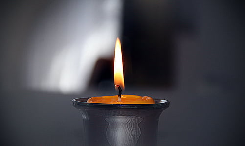 lighted candle in close up photography thumbnail