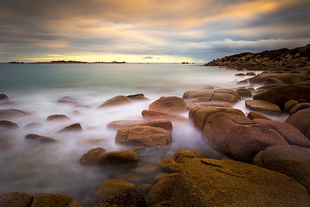 rocks beside body of water thumbnail