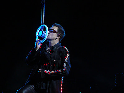 man wearing black jacket holding microphone thumbnail