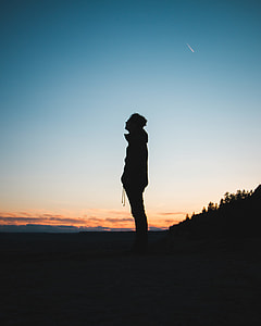 man standing on plane under blue sky during daytime thumbnail