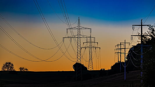 silhouette of electric towers and trees thumbnail