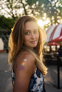 woman wearing blue and white sleeveless top thumbnail