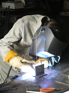 person welding a metal thumbnail