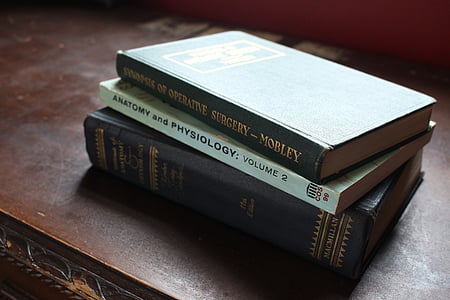 three assorted-title books stacked on table thumbnail