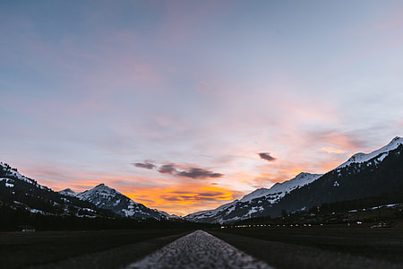 landscape photography of mountains under cloudy sky thumbnail