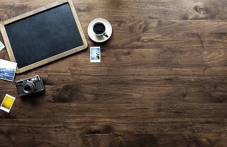 black digital camera near white ceramic teacup thumbnail