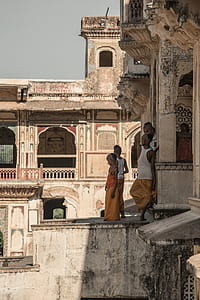 children standing beside concrete building thumbnail
