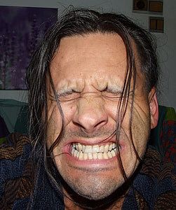 man closing his eyes and showing his teeth thumbnail
