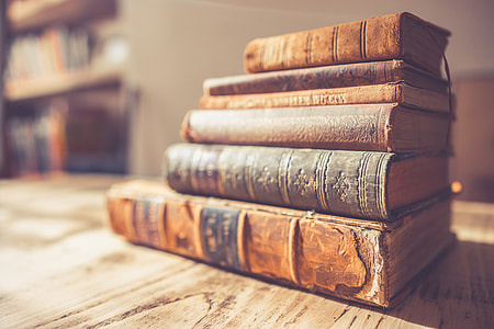 brown hardbound books on table thumbnail