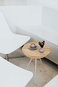 gray ceramic teacup on platter beside green leafed plant on round side table thumbnail