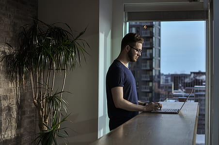 man in front of brown wooden table thumbnail