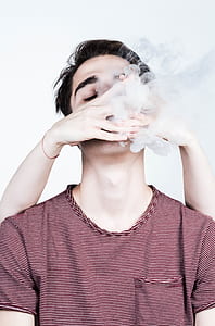 close-up photography of man wearing black and pink striped crew-neck t-shirt thumbnail