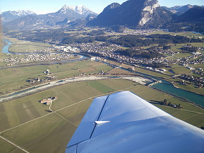 person taking photo of landmark inside plane during daytime thumbnail